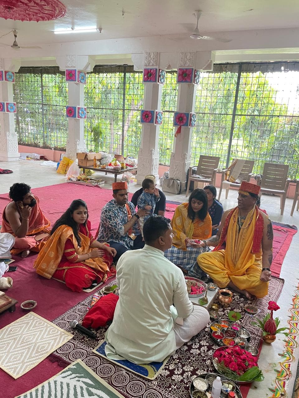 Participants seated together during a puja ceremony