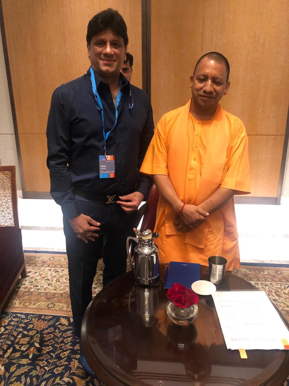 Prem Kumar Singhee standing beside a guest at a formal meeting