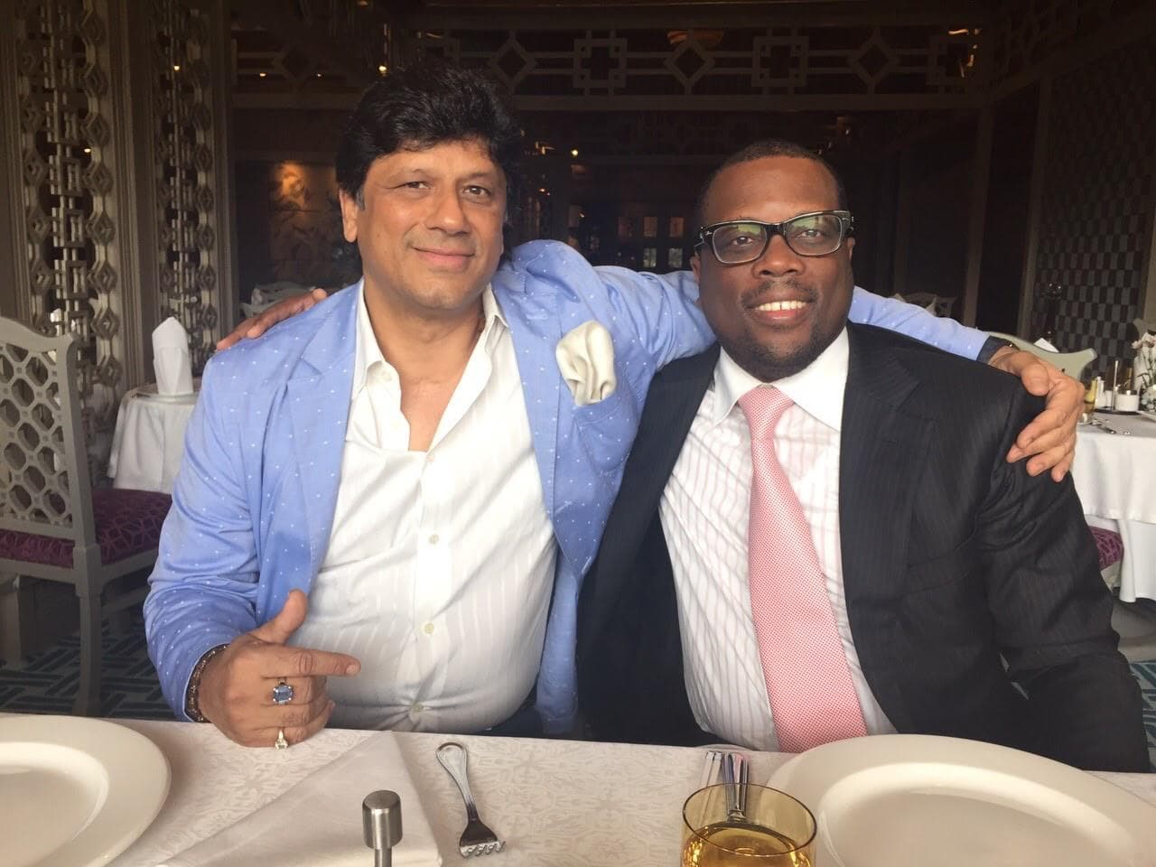 Prem Kumar Singhee seated at a dining table with a guest