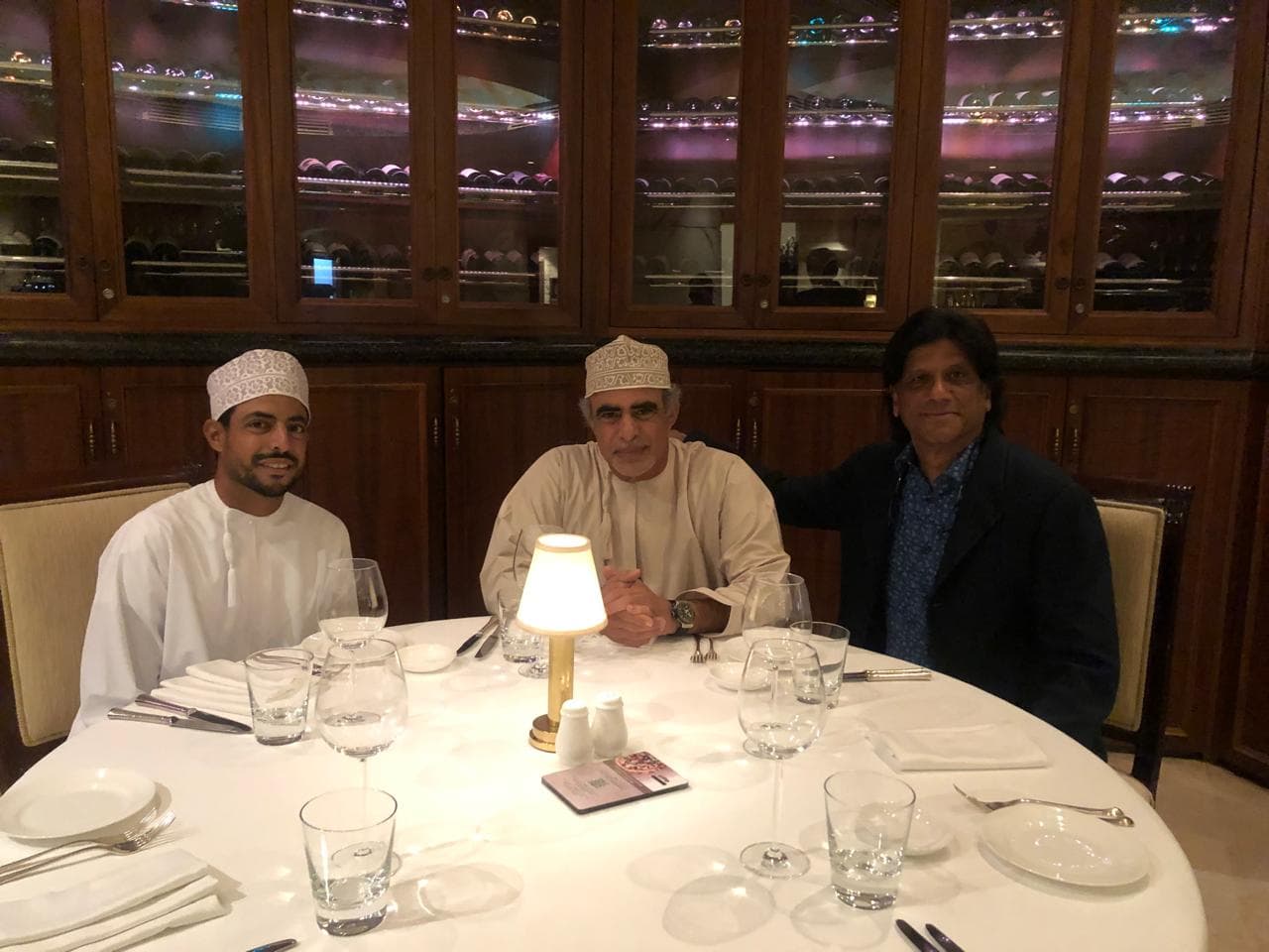 Prem Kumar Singhee seated at a round table with two guests